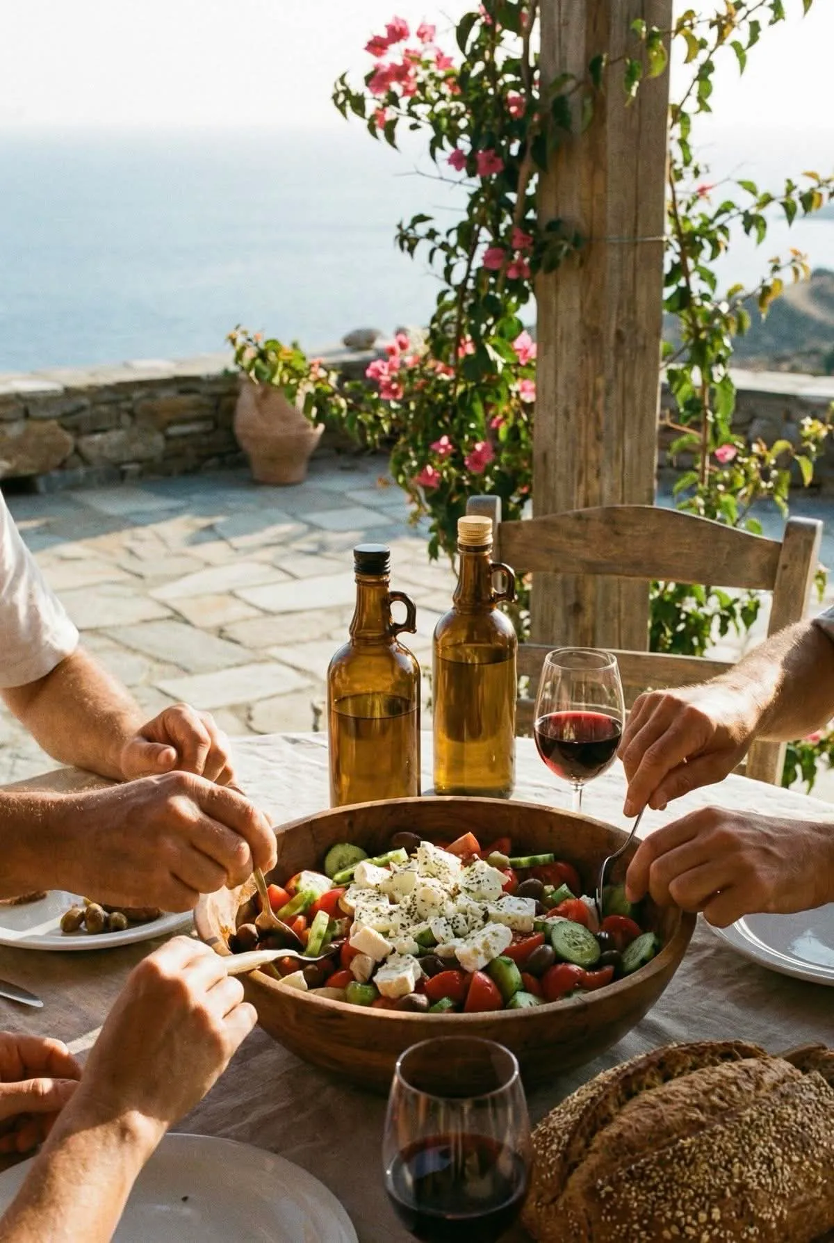 Greek salad with feta shared at a stone table by the sea