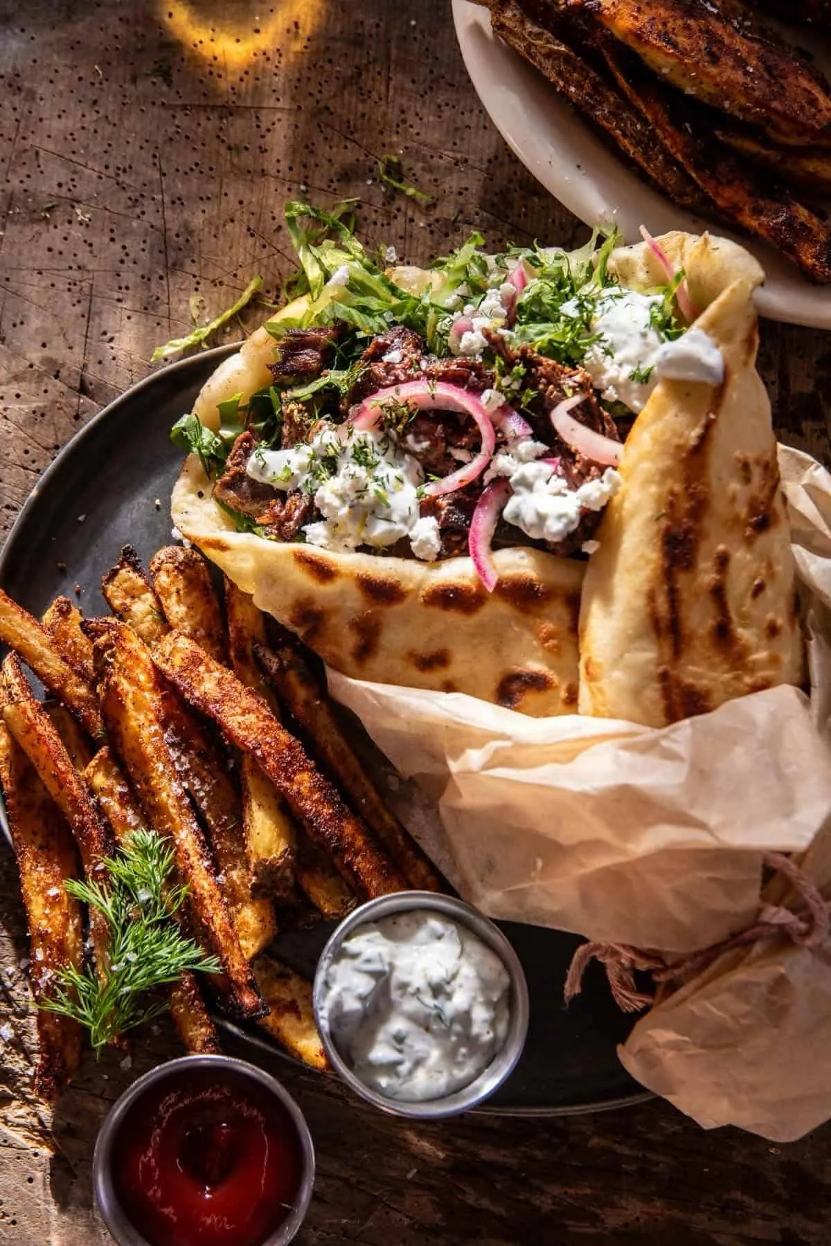 Mediterranean wrap with shawarma, pickled onions, herbs, and fries